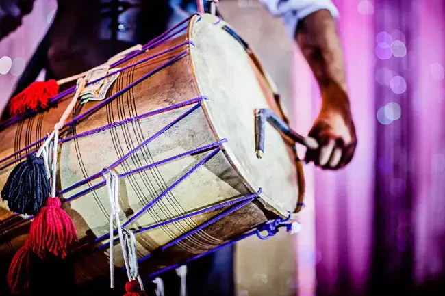 Professional live dhol player performing at Indian wedding baraat entrance ceremony
